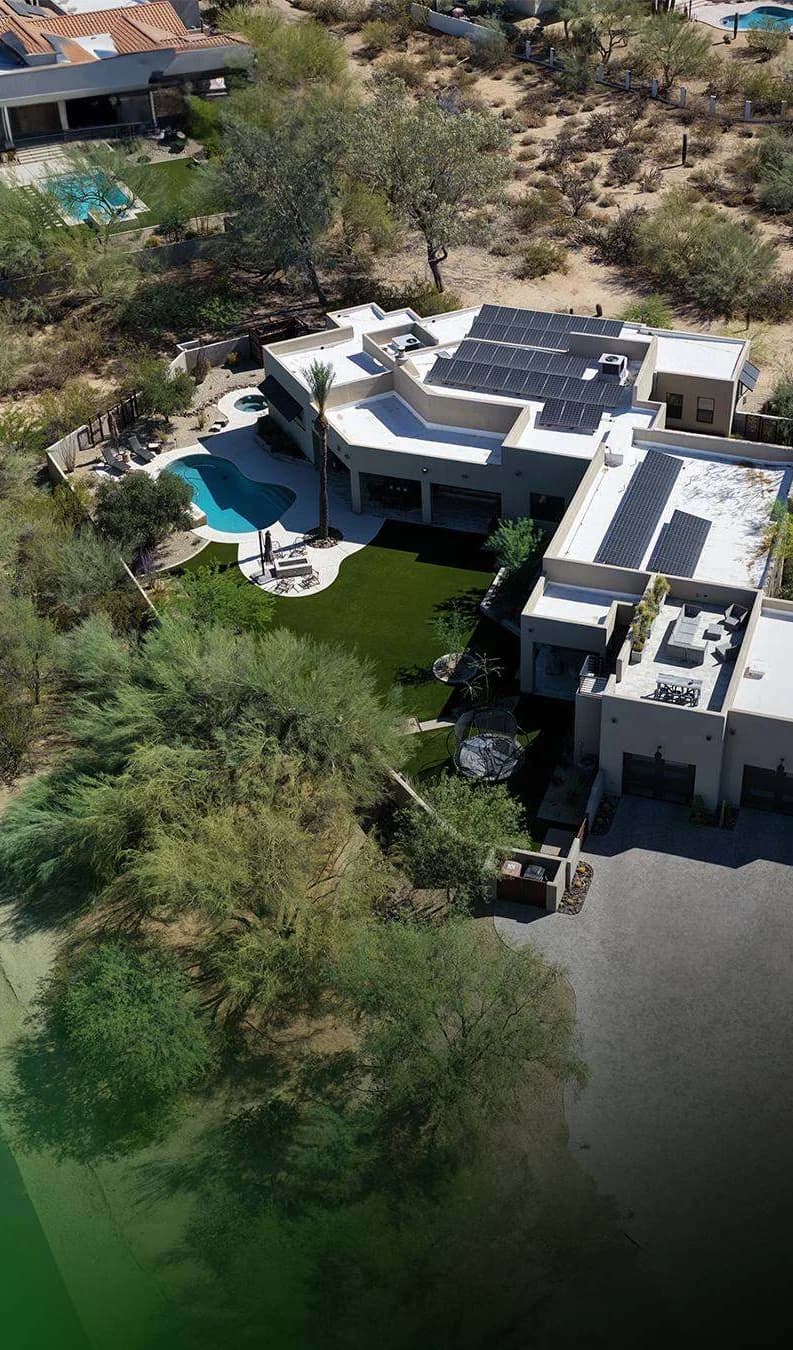 An aerial view of a desert home with a TurfIt lawn beside the pool